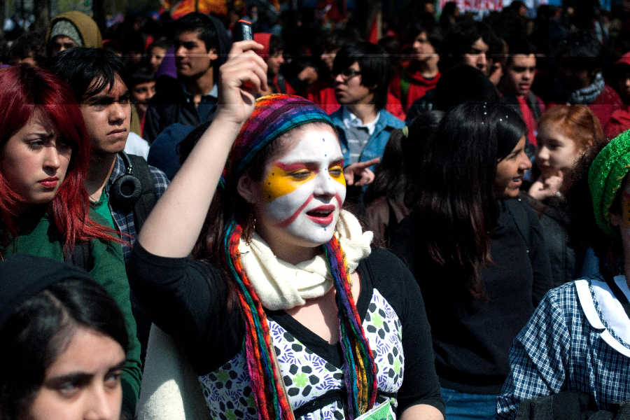Estudiante en una protesta, con una pintura en la cara